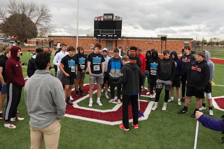 Athletes receive instruction on how to complete the standing broad jump test at last Saturday's Sharp Performance Combine. (Photo by Rayne Schmidtberger)