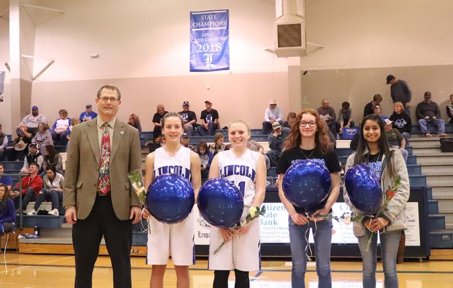 The Lincoln girls cross country team was honored for their 1A Cross Country Championship during Tuesday night's basketball games. Left-to-right: Coach Steve Crist, freshman Raegan Stewart, sophomore Jaycee Vath, freshman Shelbie Ford and senior Aubry Donley. (Photo courtesy Kae Hayworth)