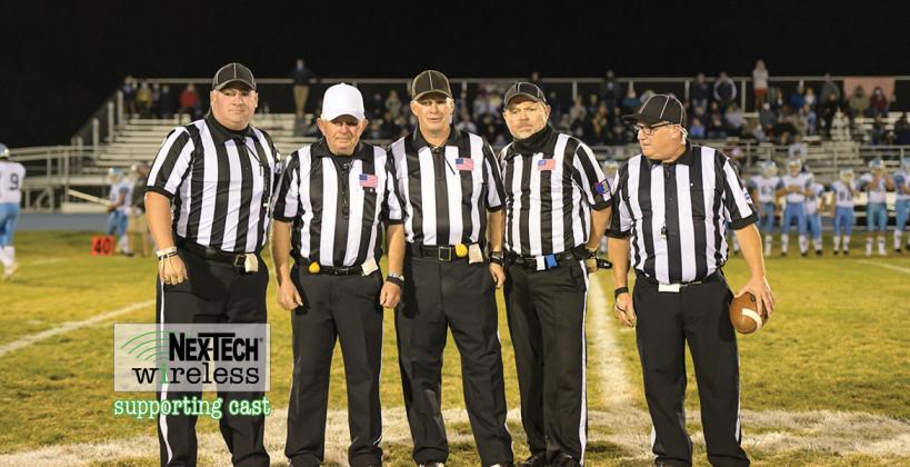 Veteran official Terrell Olson is flanked by the rest of his crew, including sons Travis and Troy, at his final game before retiring after a decades long career officiating high school sporting events in Kansas. (Photo by Karen Schroeder Photography)