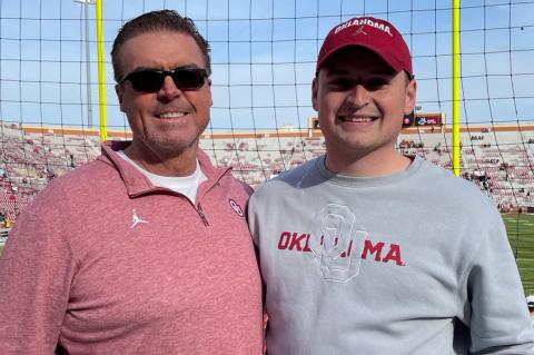 Cutline: John Kelly (right) stands with his father, Jim, at the University of Oklahoma's football stadium. (Courtesy Photo)